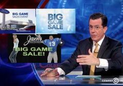 Screen Shot from Episode of Colbert Report, featuring STephen in front of commercials featuring "Big Game"