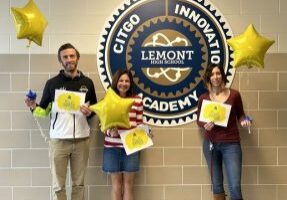Three Lemont High School faculty standing in front of CITGO Innovation Academy sign holding balloons and certificates